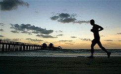 Pcture of Naples Pier and a jogger in Old Naples Florida